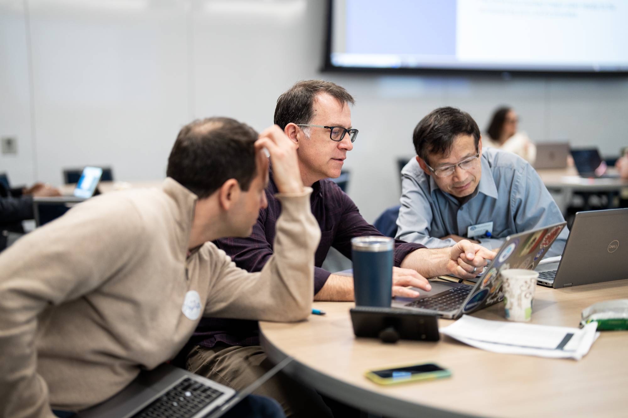 Three faculty members work together.